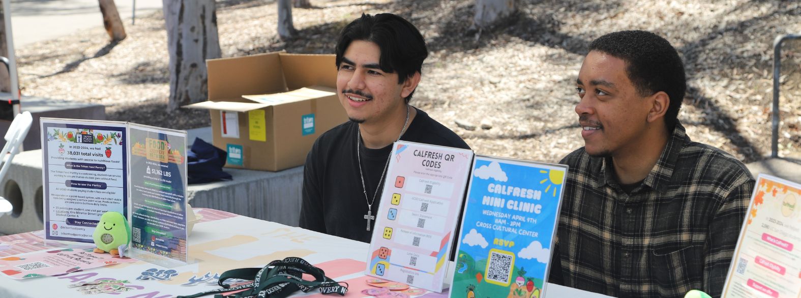 1 of 4, Two Triton Food Pantry/ Food Recovery Network student leaders tabling. 